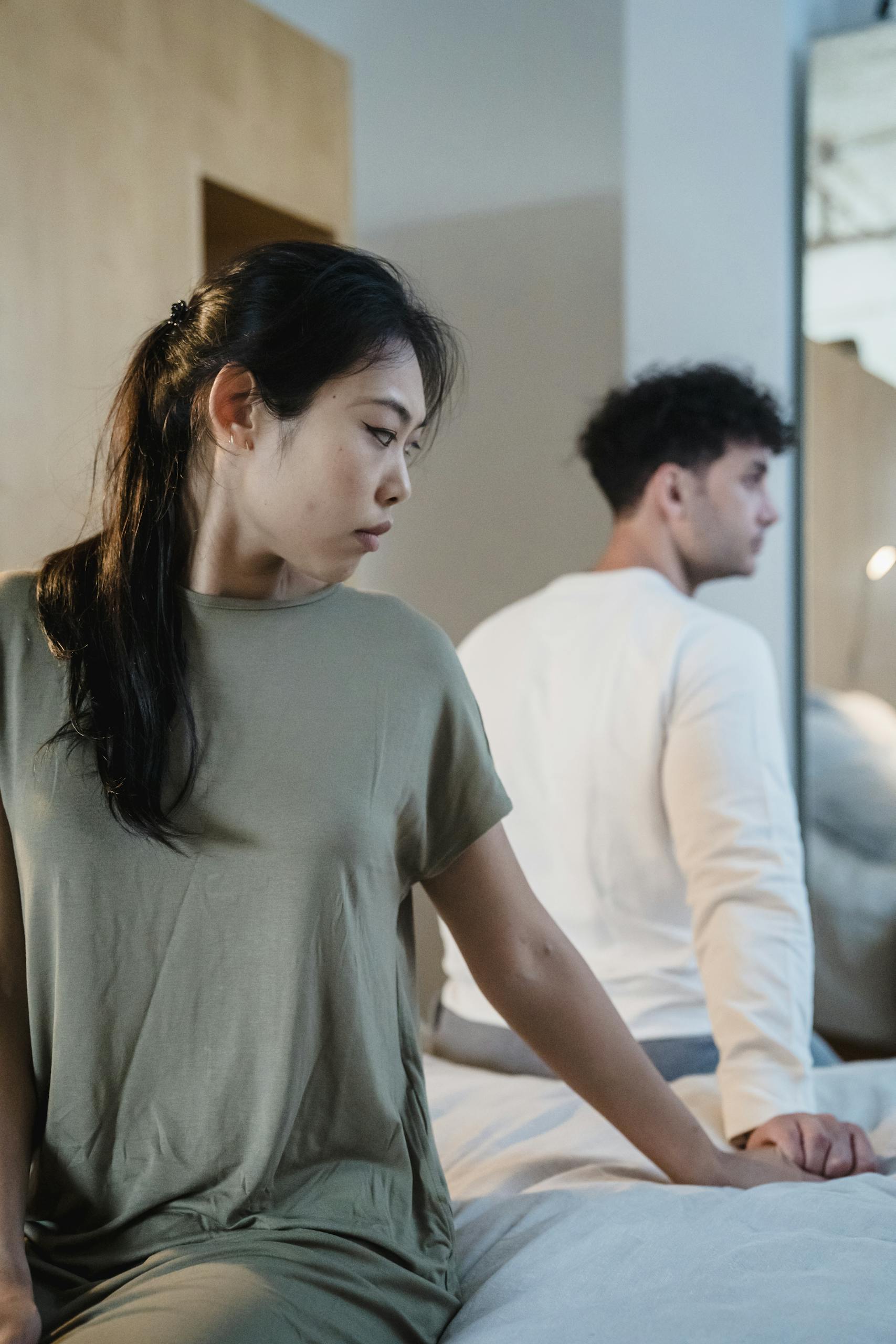 Troubled Couple Sitting on Bed